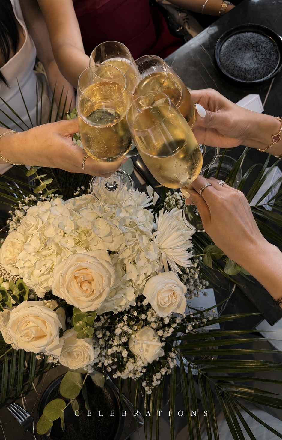 Champagne toast over an ivory centerpiece